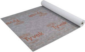 A white Tyvek groundsheet laid out on grass.