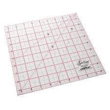A transparent quilting ruler on a cutting mat.